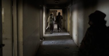 Taliban fighters walk through the alleys of an empty area at the Pul-e-Charkhi prison in Kabul, Afghanistan, Sept. 13, 2021. (AP Photo)