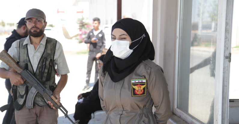 A policewoman stands at a checkpoint in al-Bab, Syria, Sept. 14, 2021. (AA PHOTO) 