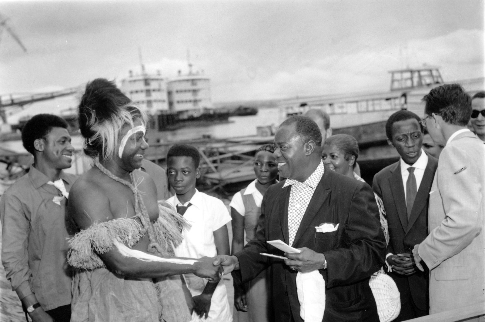 American jazz musician Louis Armstrong is greeted by Bolela, the Akuku tribal chief in costume, on the beach on his arrival in Leopoldville, Congo, Oct. 28, 1960. (AP Photo)