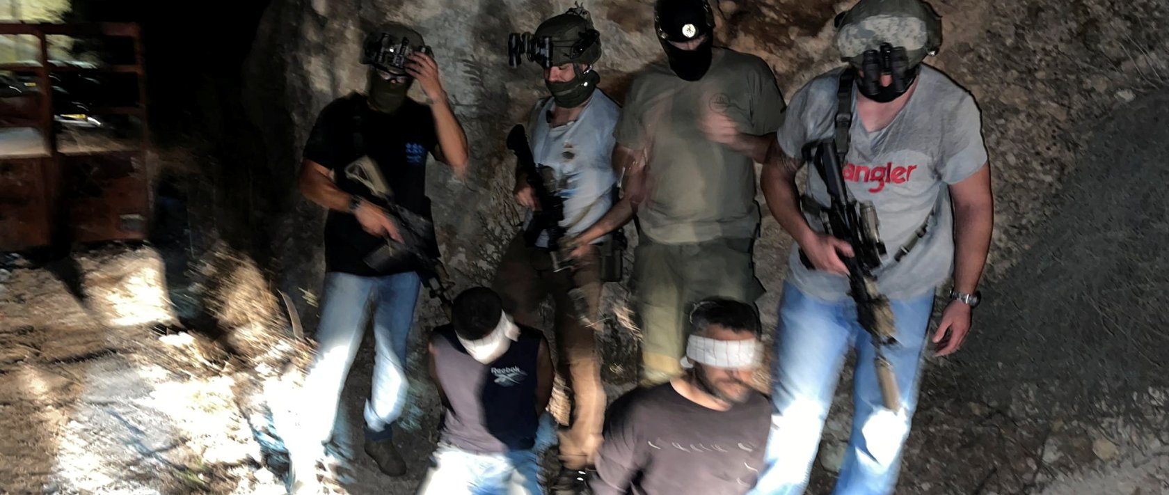 Israeli security forces stand next to Palestinians Zakaria Zubeidi and Mahmoud al-Arda after they had been arrested following their escape from Gilboa prison together with other four Palestinians, in the Israeli village of Umm Al Ghanam, Israel, September 11, 2021. (Reuters Photo)