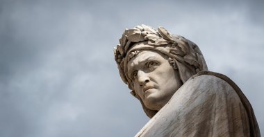 Close-up shot of the famous white marble monument of Dante Alighieri by  Enrico Pazzi in Piazza Santa Croce, next to Basilica of Santa Croce, Florence, Italy. (Shutterstock Photo)