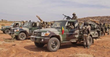 Soldiers from a Malian army special unit stand atop pick-ups mounted with machine guns, following a training exercise in the Barbe military zone, in Mopti, Mali, Nov. 24, 2012. (AP Photo)