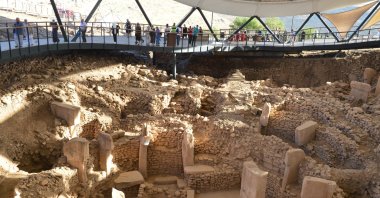 Visitors examine T-shaped obelisks in Göbeklitepe, Şanlıurfa, southeastern Turkey, Sept. 15, 2021. (AA Photo)