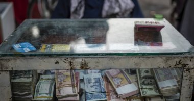 An Afghan money changer waits for customers in Kabul's Old City, Afghanistan, Sept. 14, 2021. (AP Photo)
