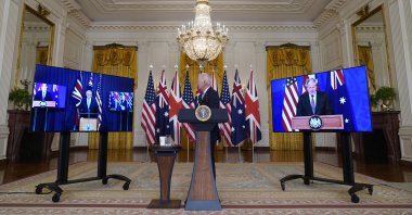 U.S. President Joe Biden, listens as he is joined virtually by Australian Prime Minister Scott Morrison, left, and British Prime Minister Boris Johnson, speaks about a national security initiative in the East Room of the White House in Washington, Wednesday, Sept. 15, 2021. (AP Photo)