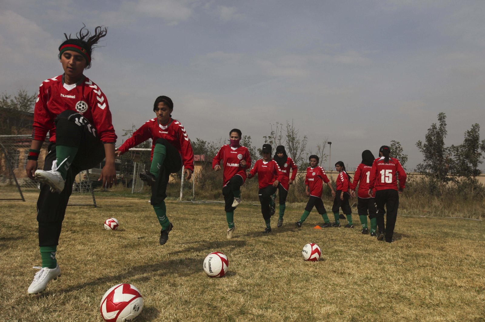 Members of the Afghan women's national football team warm up before a friendly match in Kabul, Afghanistan, Oct. 29, 2010. (AP Photo)