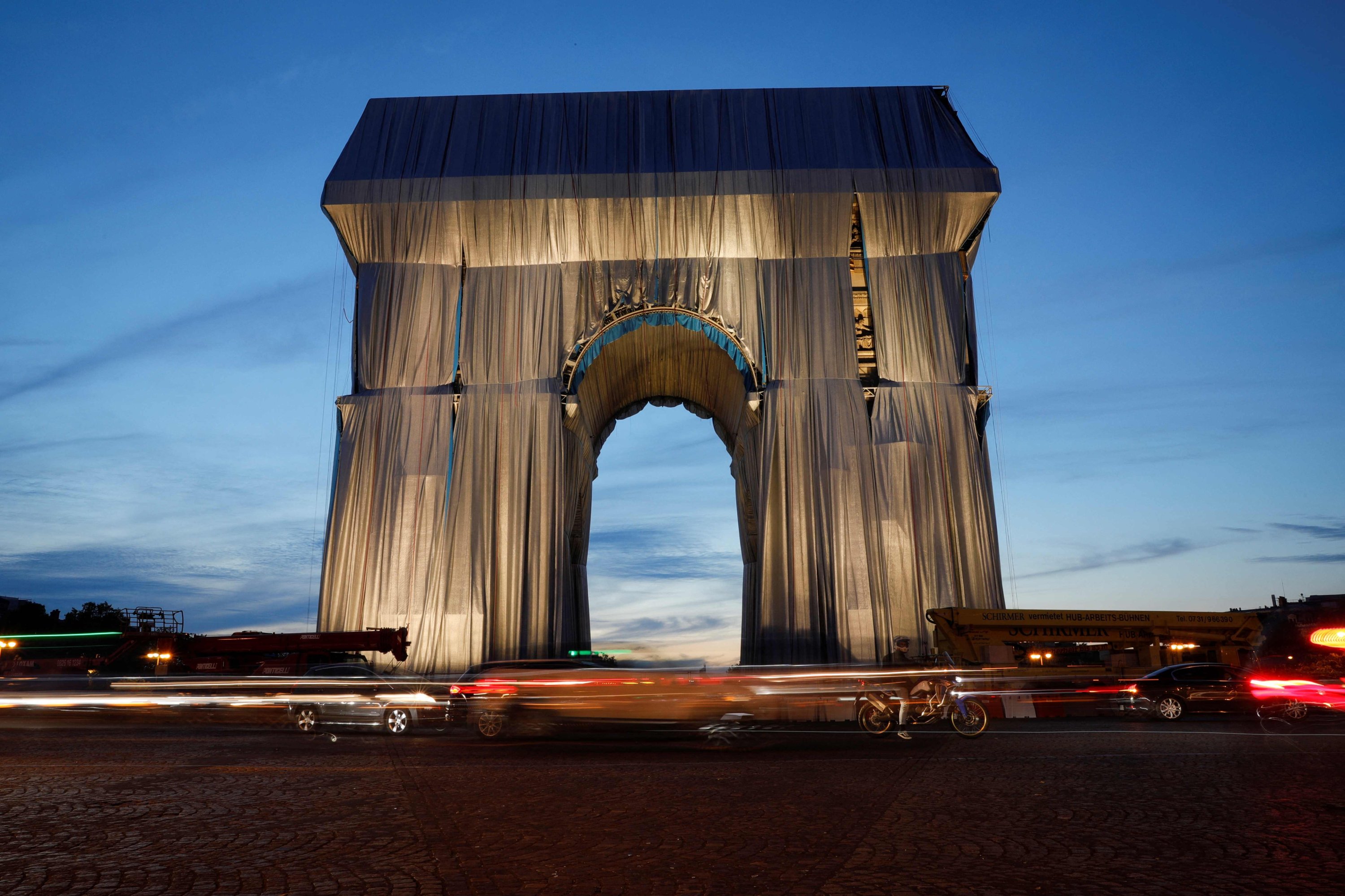 The photograph shows the Arc de Triomphe wrapped in silver-blue fabric as it was designed by the late artist Christo, Paris, France, Sept. 13, 2021 (AFP Photo)