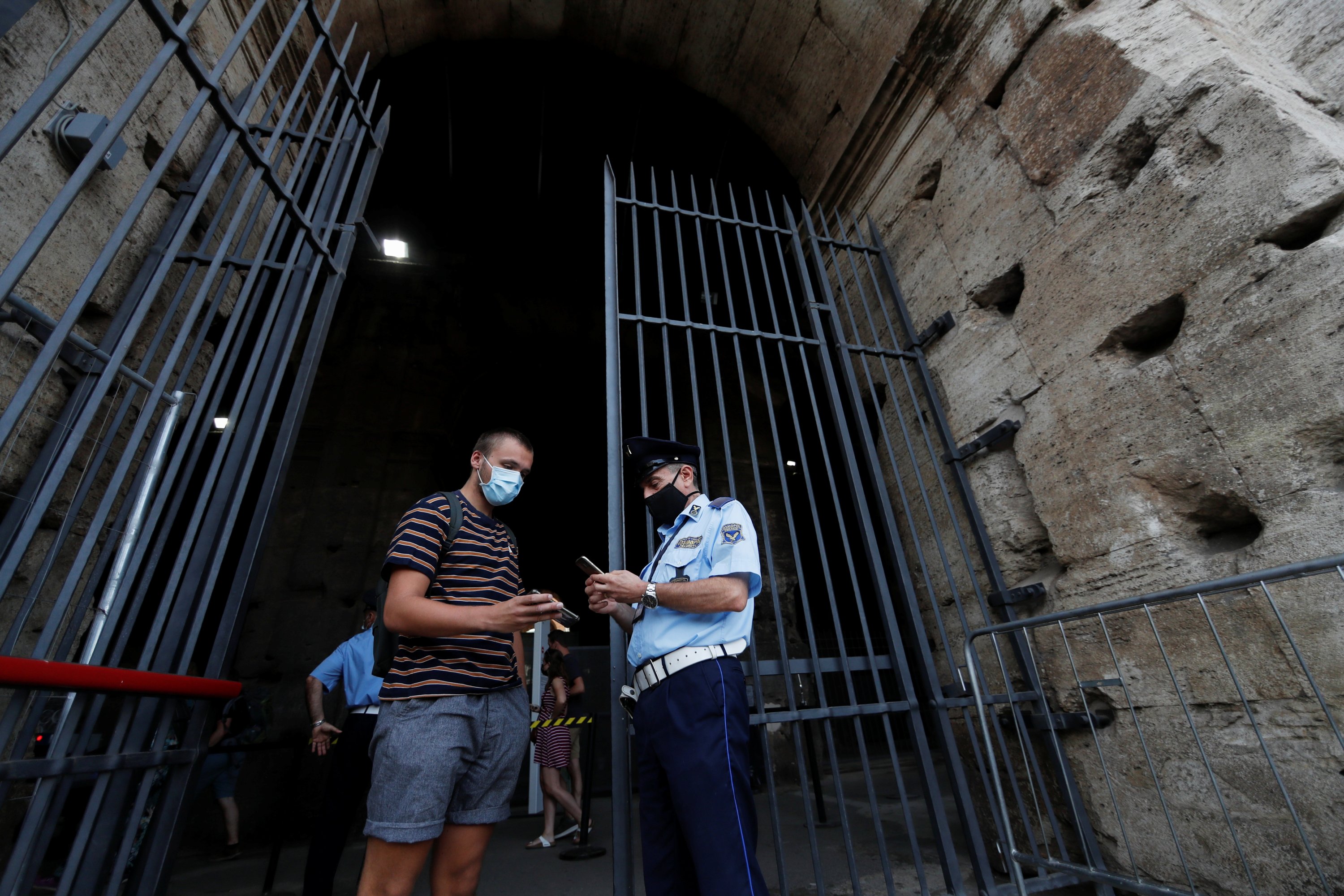 A tourist shows his "Green Pass," a document showing proof of COVID-19 immunity, as he enters the Colosseum, in Rome, Italy, Sept. 16, 2021. (Reuters Photo)