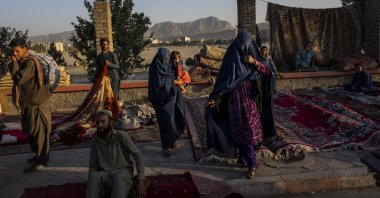 Afghan women walk through a second-hand market where many families sold their belongings before leaving the country or due to financial struggle, in Kabul, Afghanistan, Sept. 15, 2021. (AP Photo)