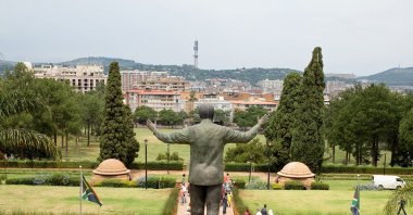 People take images of the nine-meter-tall bronze statue of former president Nelson Mandela of South Africa at the Union buildings in Pretoria, South Africa, March 22, 2015. (Shutterstock Photo)