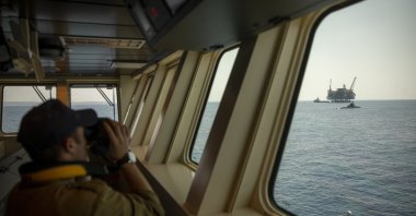 An Israeli Navy sailor looks at Israel's offshore Leviathan gas field from on board the Israeli Navy Ship Atzmaut as a submarine patrols in the Mediterranean Sea, Sept. 1, 2021. (AP Photo)