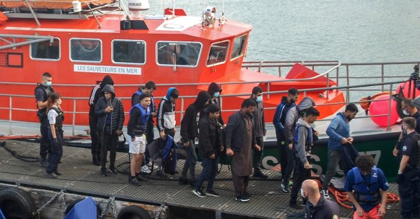 Iraqi, Iranian and Afghan migrants, with two minors among their number, disembark from a vessel after being rescued as their inflatable boat was filling with water on the English Channel, in Calais, northern France on Sept. 15, 2021. (AFP Photo)