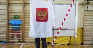 A man fills out his ballot in a voting booth during the parliamentary elections in Moscow, Russia, Sept. 17, 2021. (AP Photo)