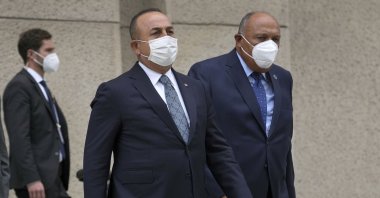 Turkey’s Foreign Minister Mevlüt Çavuşoğlu (L) and his counterpart from Egypt, Sameh Shoukry (R) arrive for a group photo during the Second Berlin Conference on Libya at the foreign office in Berlin, Germany, June 23, 2021. (AP Photo)