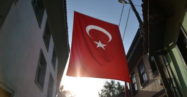 Turkish flag hangs between two buildings. (Shutterstock Photo)