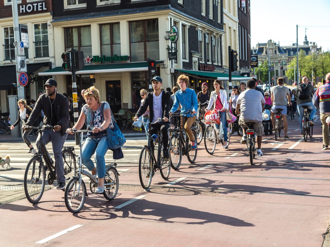 People riding bicycles in a historical part of Amsterdam, The Netherlands, June 16, 2016. (Shutterstock Photo)