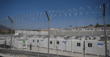 A security guard stands alert in the new multi-purpose reception and identification migrant center that was constructed near Vathy, on the eastern Aegean island of Samos, Greece, Sept. 18, 2021. (AFP Photo)