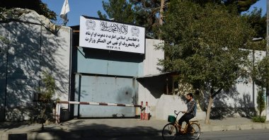 A man rides his bike past an entrance gate of the Ministry for the Promotion of Virtue and Prevention of Vice in Kabul, Afghanistan, Sept. 17, 2021. (Photo by Hoshang Hashimi via AFP)