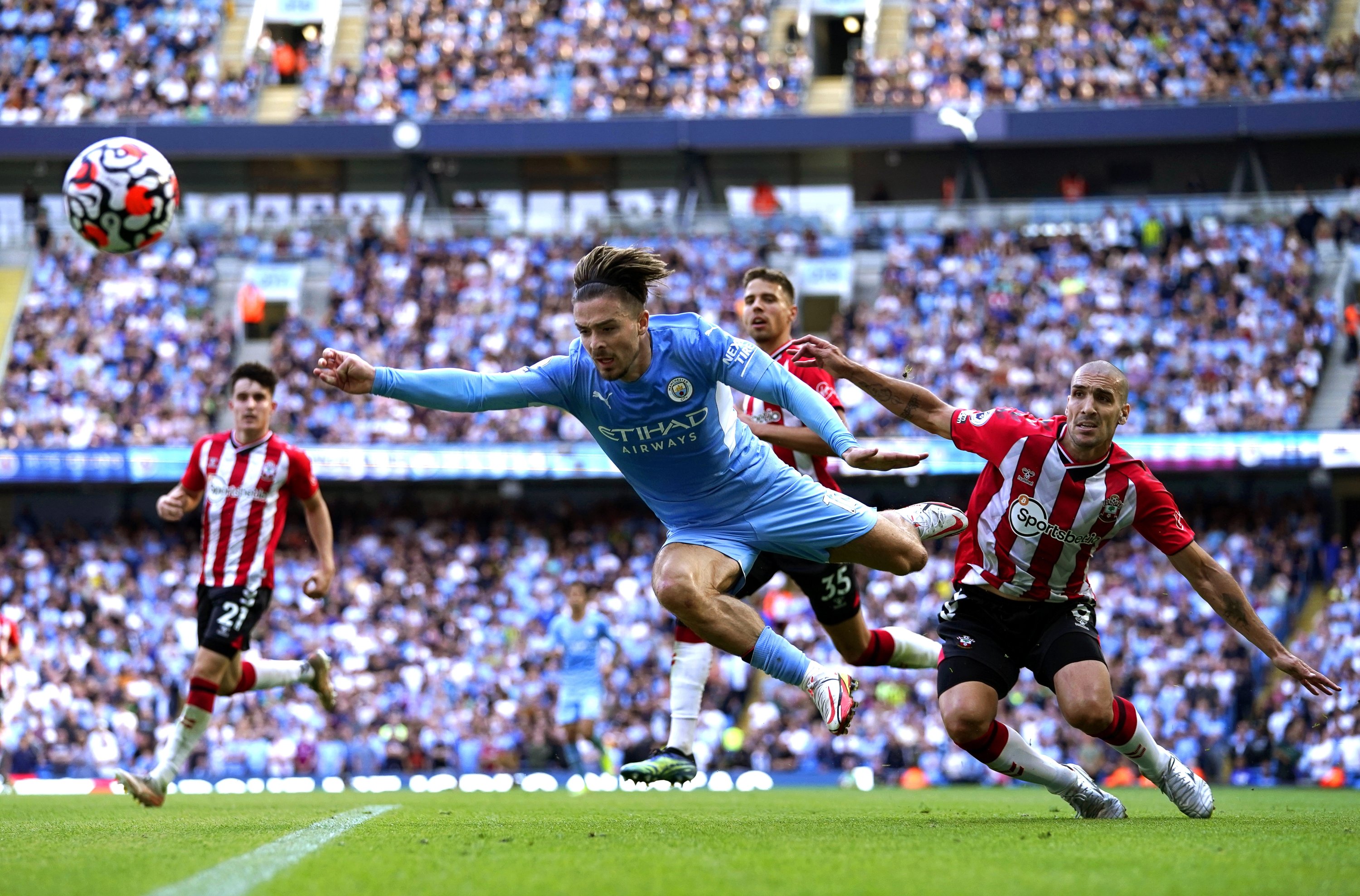 Manchester City's Jack Grealish (C) in action against Southampton's James Ward-Prowse (R) during a Premier League match in Manchester, England, Sept. 18, 2021. (EPA Photo)