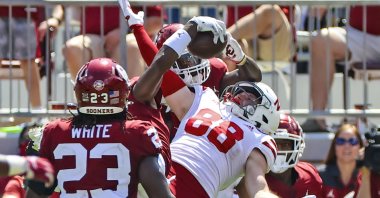 Oklahoma Sooners cornerback D.J. Graham (middle) makes an interception in front of Nebraska Cornhuskers wide receiver Levi Falck (88) during the fourth quarter at Gaylord Family-Oklahoma Memorial Stadium, Norman, Oklahoma, Sept. 18, 2021. (Kevin Jairaj-USA TODAY Sports via REUTERS)