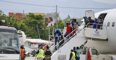 Haitians who were deported from the United States deplane at the Toussaint Louverture International Airport, in Port au Prince, Haiti, Sept. 19, 2021. (AP Photo)