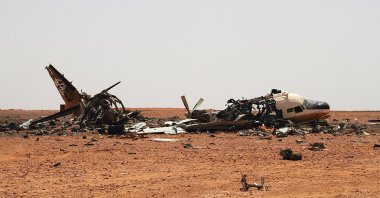 The wreckage of a plane is scattered in the desert outside a military base approximately 45 kilometers outside of Bani Walid, Libya, Saturday, Sept. 3, 2011. (AP File Photo)