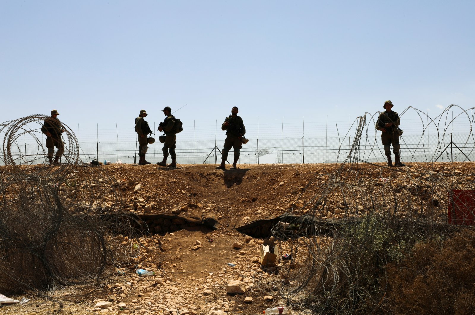 Israeli soldiers guard a fence leading to the Israeli-occupied West Bank, as part of search efforts to capture six Palestinian men who had escaped from Gilboa prison earlier this week, by the village of Muqeibila in northern Israel, Sept. 9, 2021. (Reuters Photo)