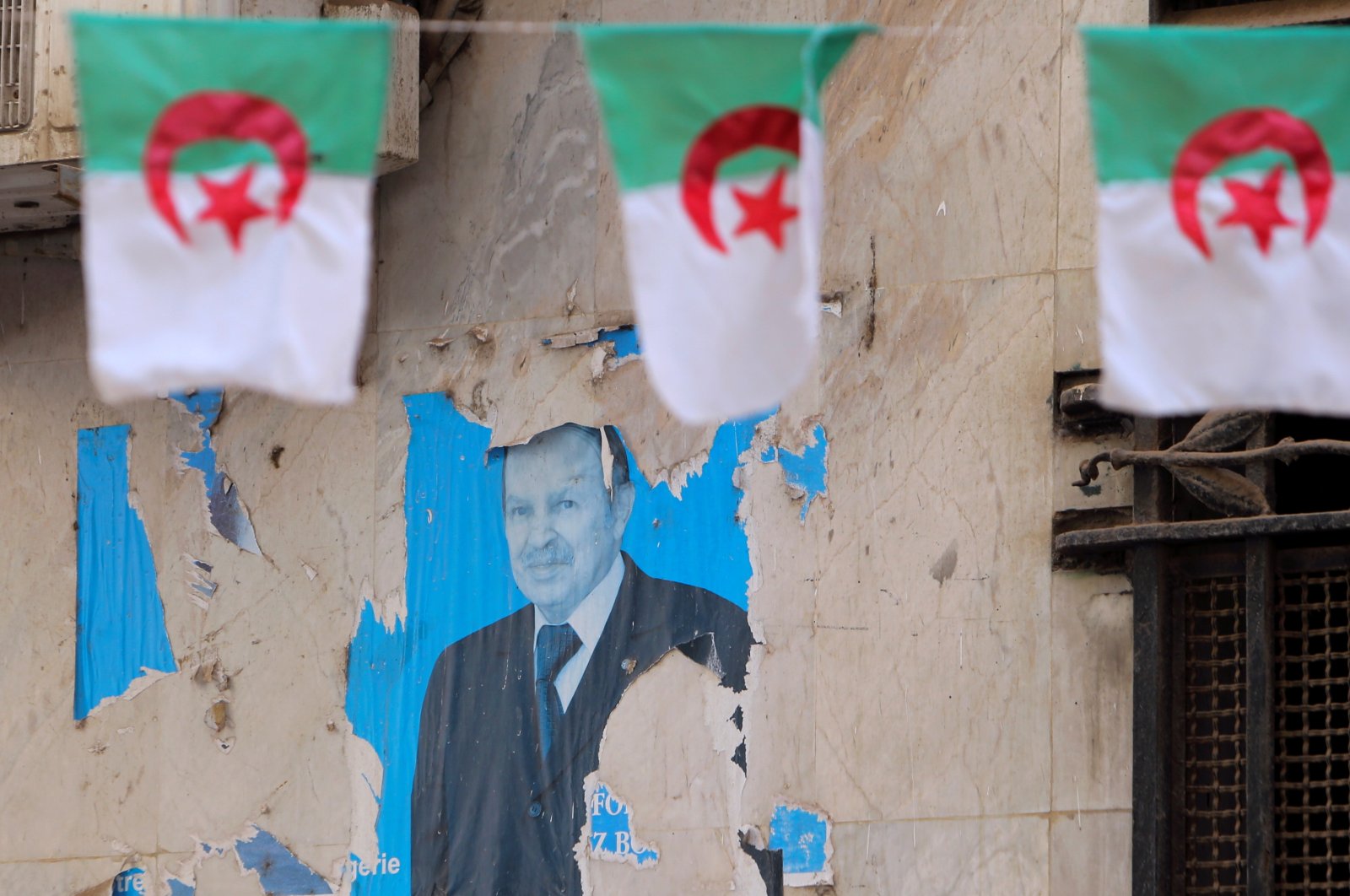 An old poster of former Algerian President Abdelaziz Bouteflika, following his death, is seen, Algiers, Algeria, Sept.18, 2021. (Reuters Photo)