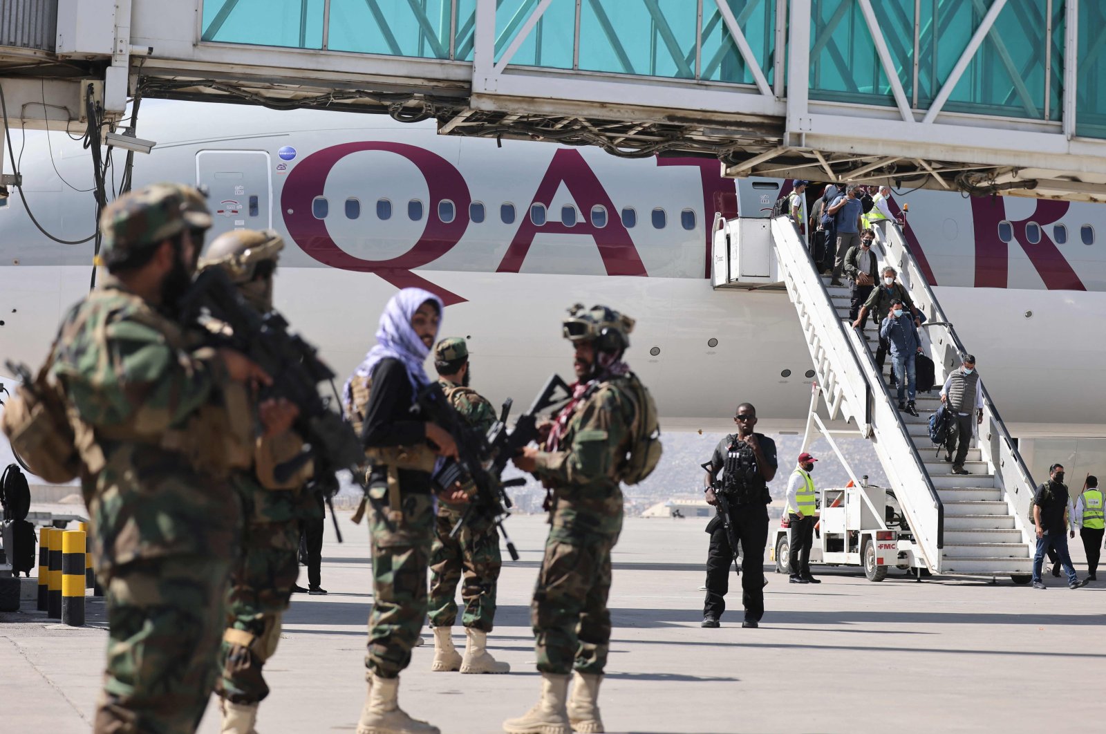 Fighters of the Taliban Badri 313 military unit stand guard as passengers on board a Qatar Airways aircraft disembark at the airport in Kabul, Afghanistan, Sept. 14, 2021. (AFP File Photo)