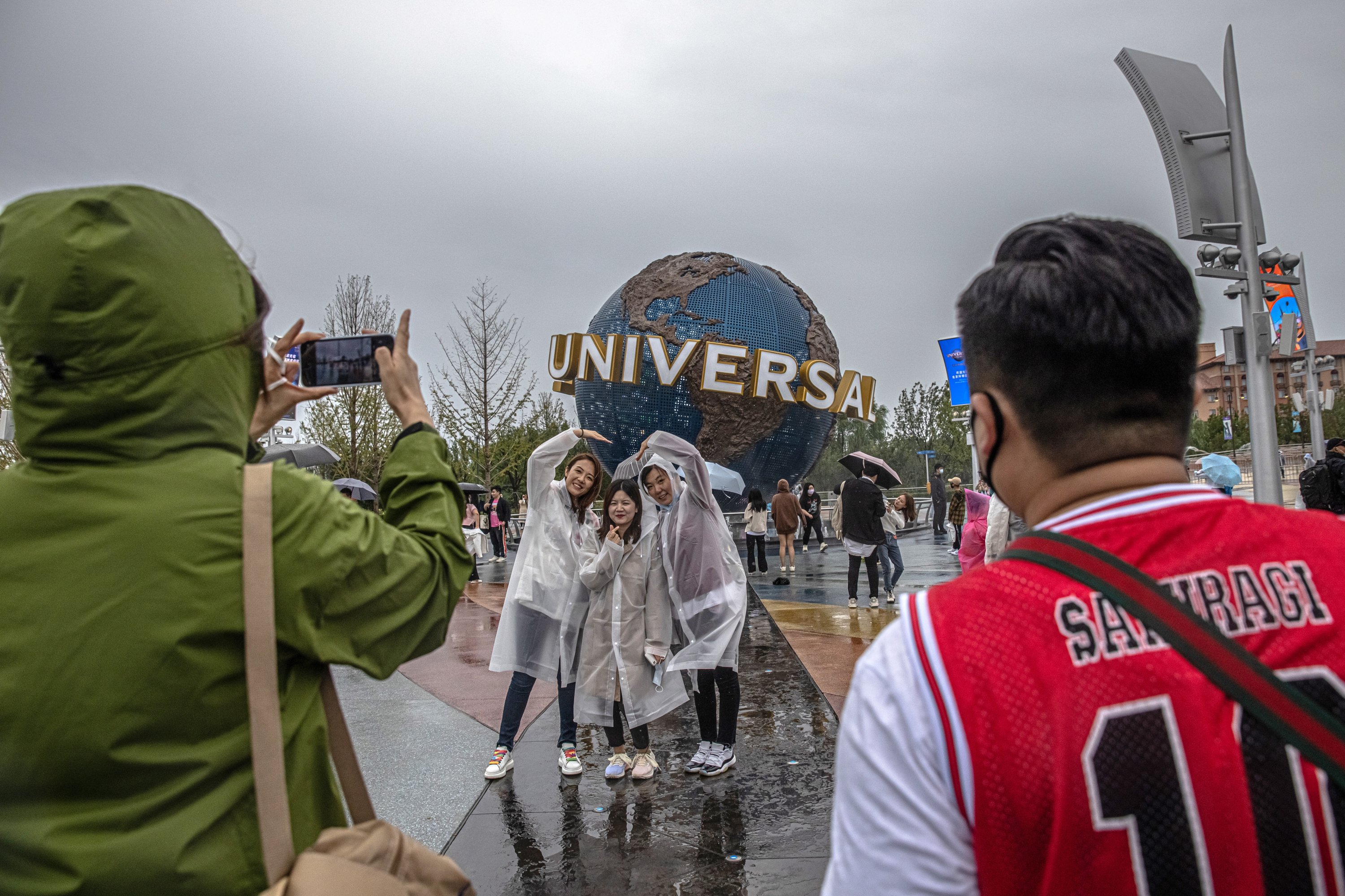 Visitors pose for photos near the entrance to Universal Studios Beijing on the official opening day, in Beijing, China, Sept. 20, 2021. (EPA Photo).