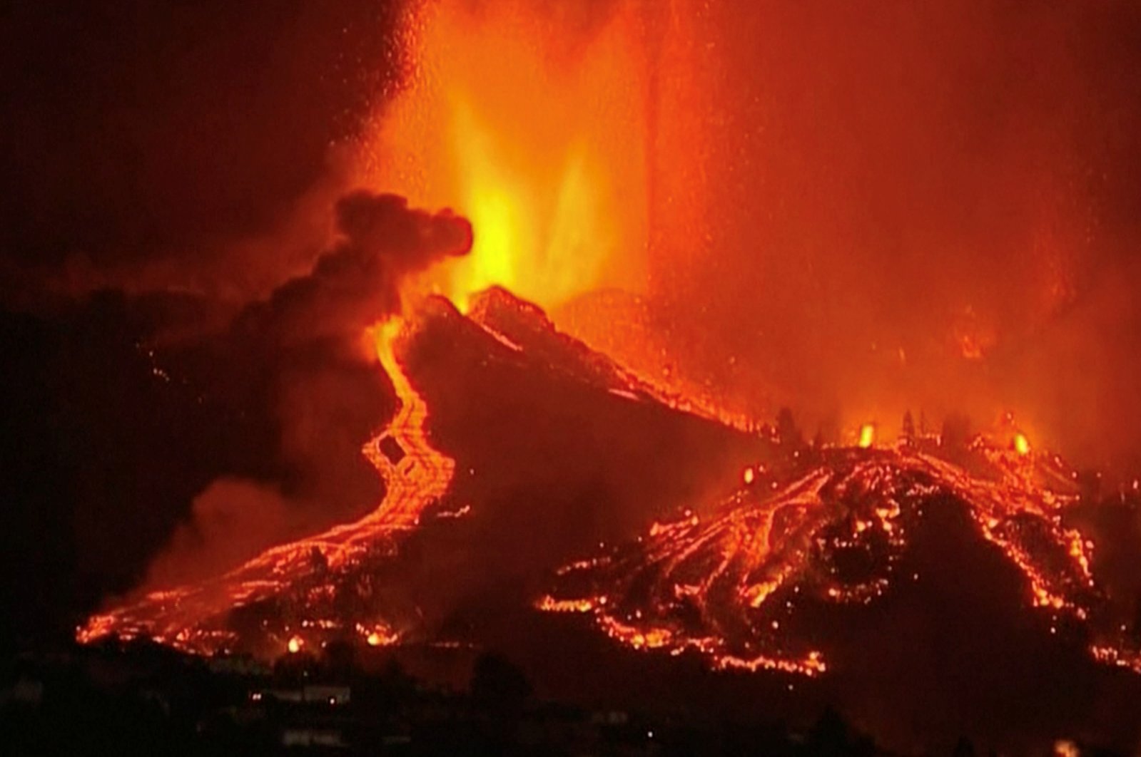 In this screen grab taken from a video, lava pours out of a volcano in the Cumbre Vieja national park at El Paso, on the Canary Island of La Palma, Sept. 19, 2021. (Reuters Photo)