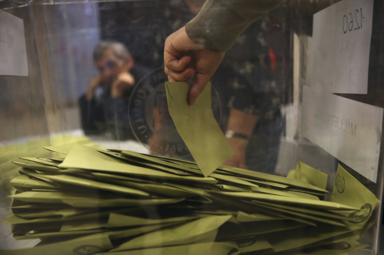 A Turkish election official removes the voting envelopes from a ballot box shortly after the polling stations closed at the end of the election day, in Istanbul, Turkey, Nov. 1, 2015. (AP File Photo)