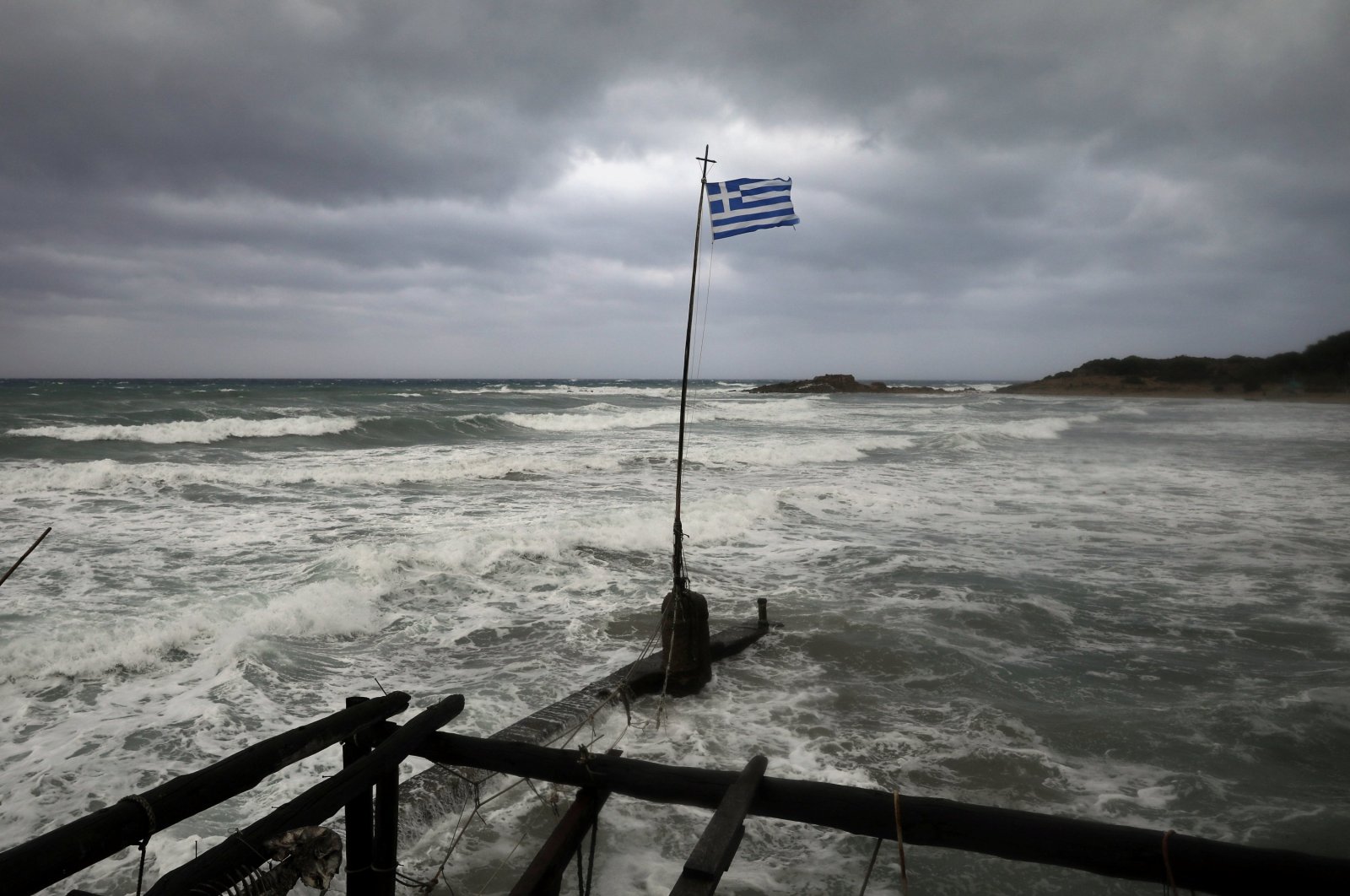 A Greek flag flutters on a beach near the town of Kyllini, as a rare storm, known as a Medicane (Mediterranean hurricane), hits western Greece, Sept. 18, 2020. (Reuters File Photo)