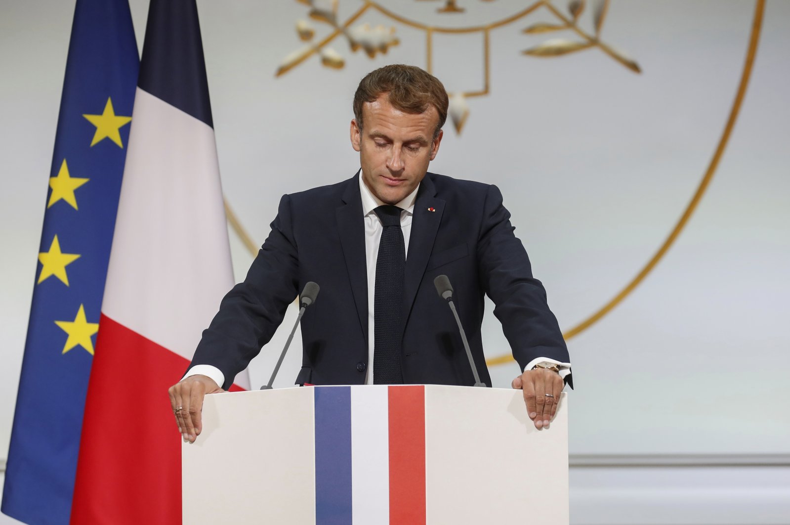 French President Emmanuel Macron pauses as he delivers a speech during a meeting in memory of the Algerians who fought alongside French colonial forces in Algeria's war of independence, known as Harkis, at the Elysee Palace in Paris, France, Sept. 20, 2021. (Pool Photo via AP)