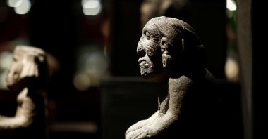 A pre-Columbian stone figure of the kneeling goddess of fertility and earth, Coatlicue, is presented to the press at the Drouot auction house in Paris, France, Sept. 18, 2019. (Reuters Photo)