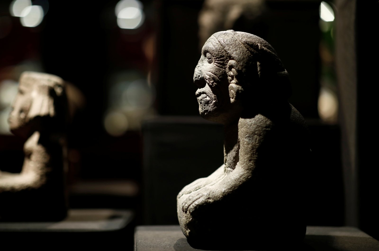 A pre-Columbian stone figure of the kneeling goddess of fertility and earth, Coatlicue, is presented to the press at the Drouot auction house in Paris, France, Sept. 18, 2019. (Reuters Photo)