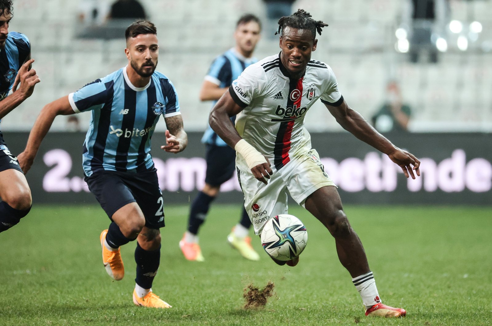 Beşiktaş's Michy Batshuayi (R) is seen in action with Adana Demirspor players in this photo taken on Sept. 21, 2021 at the Vodafone Park in Istanbul (AA Photo)