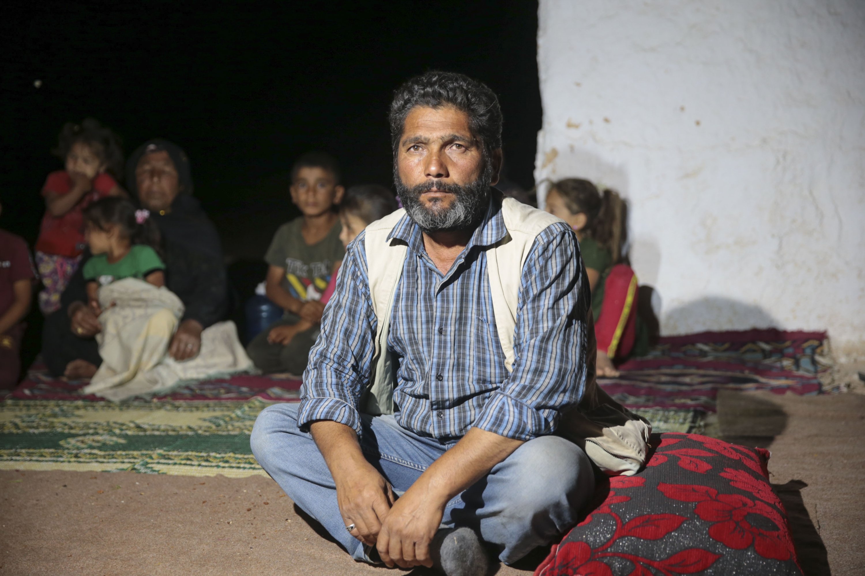 Seasonal laborer Hikmet Aslantay and his family sits outside their house, in Şanlıurfa, southeastern Turkey, Sept. 21, 2021. (AA PHOTO) 