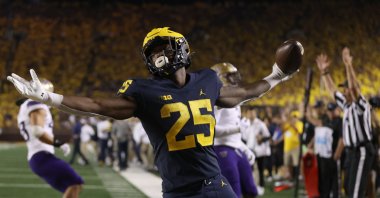 Hassan Haskins (25) of the Michigan Wolverines celebrates a second-half touchdown against the Washington Huskies at Michigan Stadium, Ann Arbor, Michigan, U.S., Sept. 11, 2021. (AFP Photo)