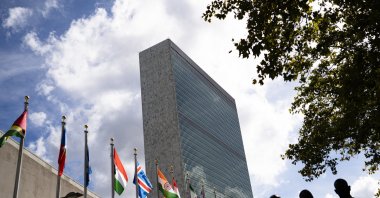 Members of a delegation's entourage wait outside a security checkpoint on the sidewalk in front of the U.N. headquarters, during the 76th Session of the U.N. General Assembly in New York, U.S., Sept. 21, 2021. (AP Photo)