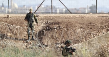 Israeli soldiers take positions along the border as they search for two Palestinians who broke out of a maximum-security prison last week, on a road leading to the West Bank town of Jenin, near Gan Ner, Israel, Sept. 12, 2021. (AP Photo)