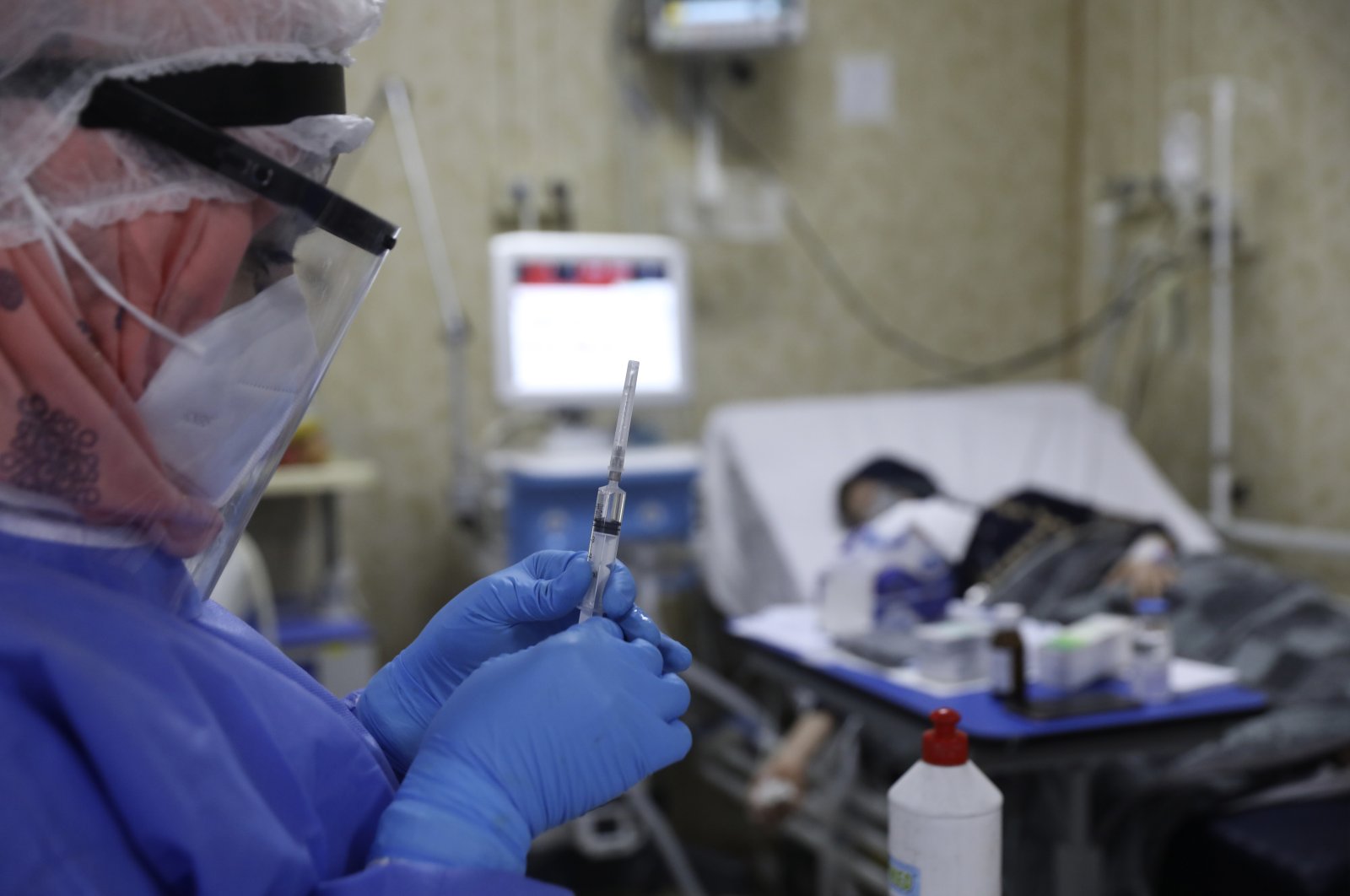 A nurse prepares a syringe for a patient infected with the coronavirus in the intensive care unit at the Syrian American Medical Society Hospital, in the city of Idlib, northwest Syria, Monday, Sept. 20, 2021. (AP Photo)