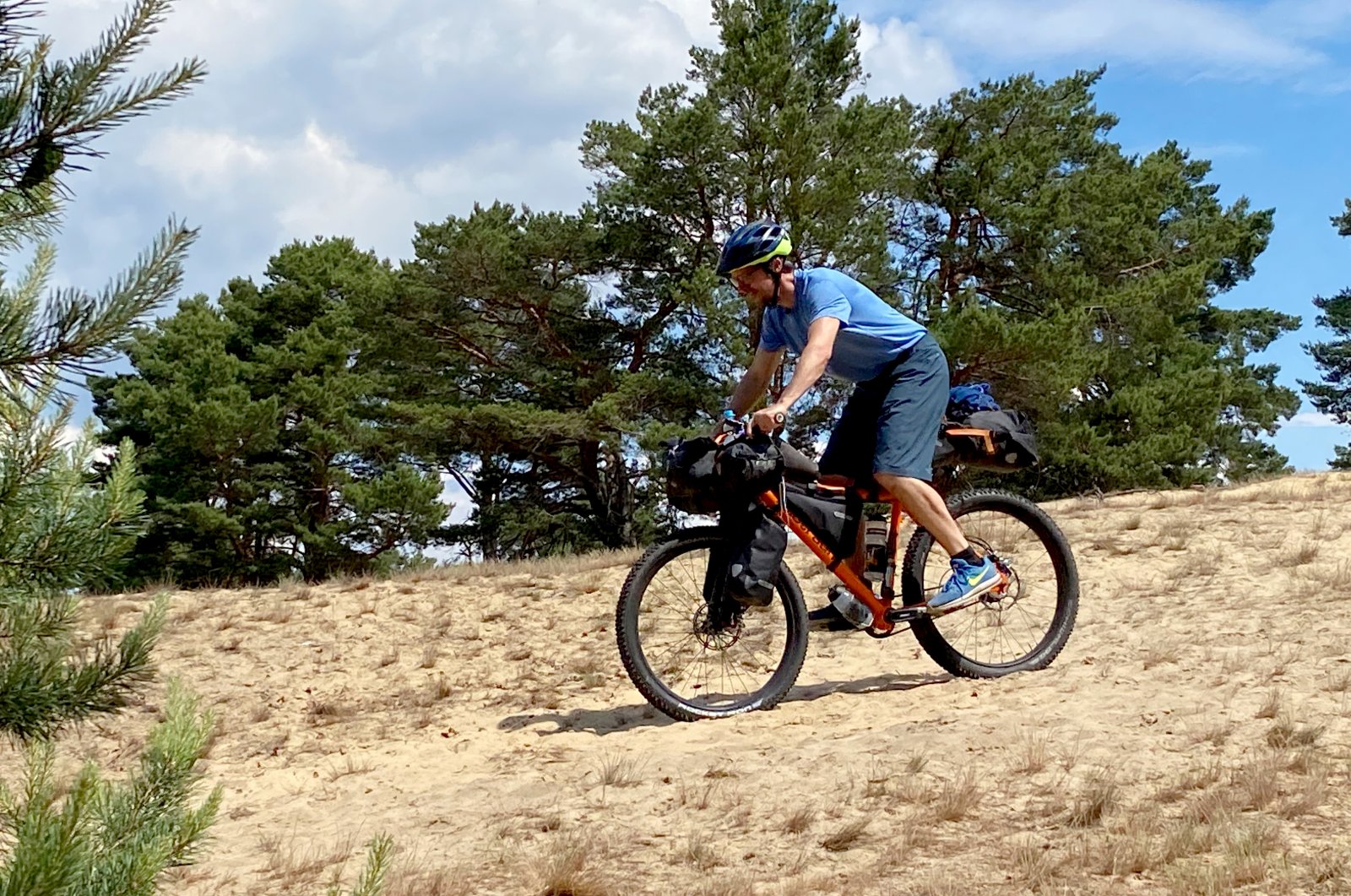 Thanks to its wide tread tires, this bikepacking bike – similar to a mountain bike – masters difficult terrain like this sandhill far better than a trekking bike with narrower tires. (DPA Photo)