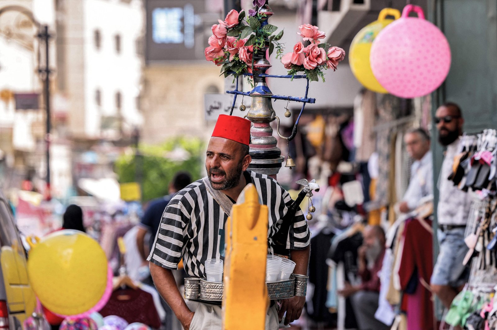 A Palestinian fresh juice street vendor calls for customers at a market in the old city of Bethlehem in the Israeli-occupied West Bank, Sept. 14, 2021. (AFP Photo)