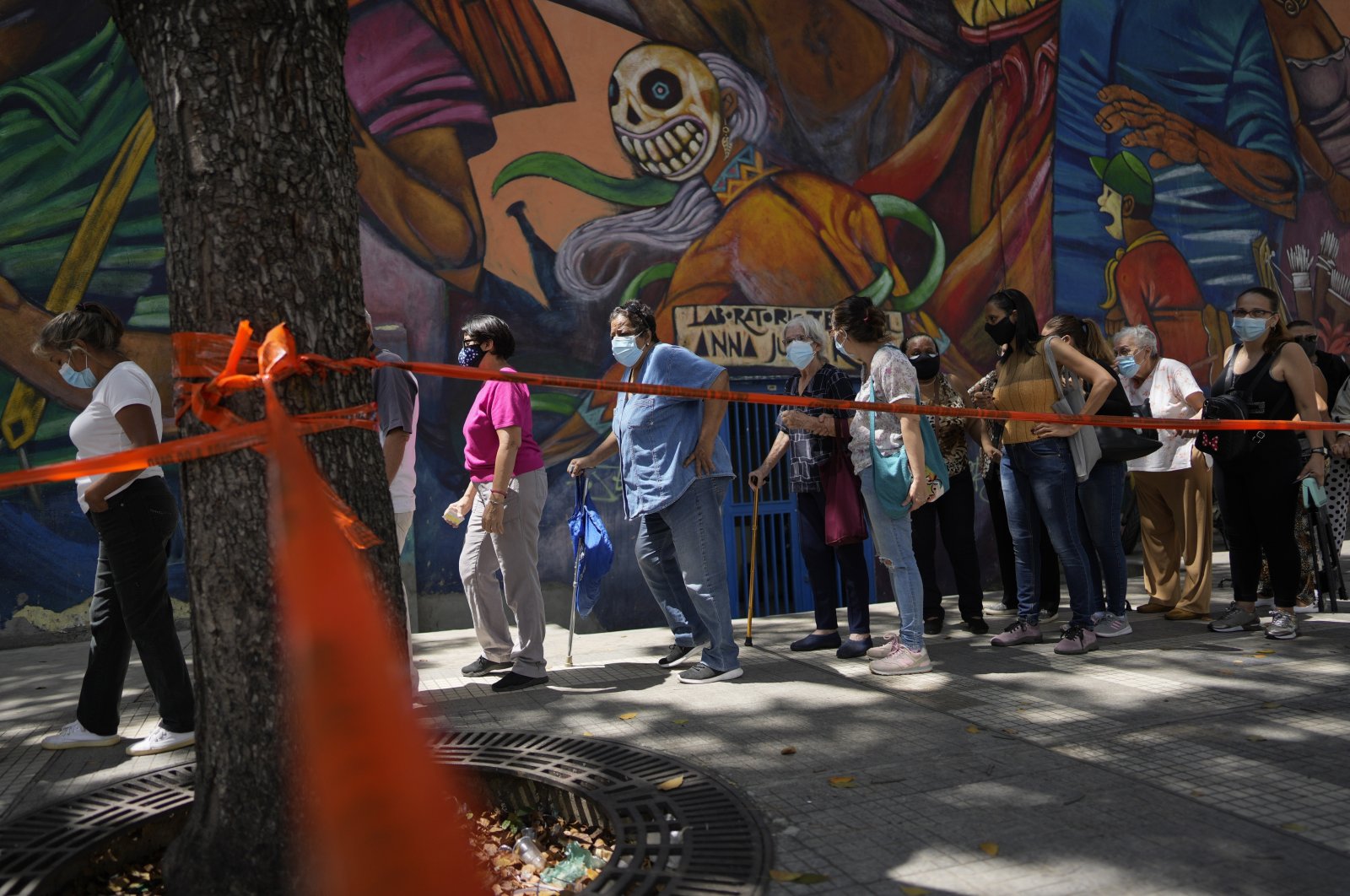 Residents stand in line to be injected with a second dose of the Sputnik V COVID-19 vaccine after more than a three-month delay, in Caracas, Venezuela, Sept. 21, 2021. (AP Photo)