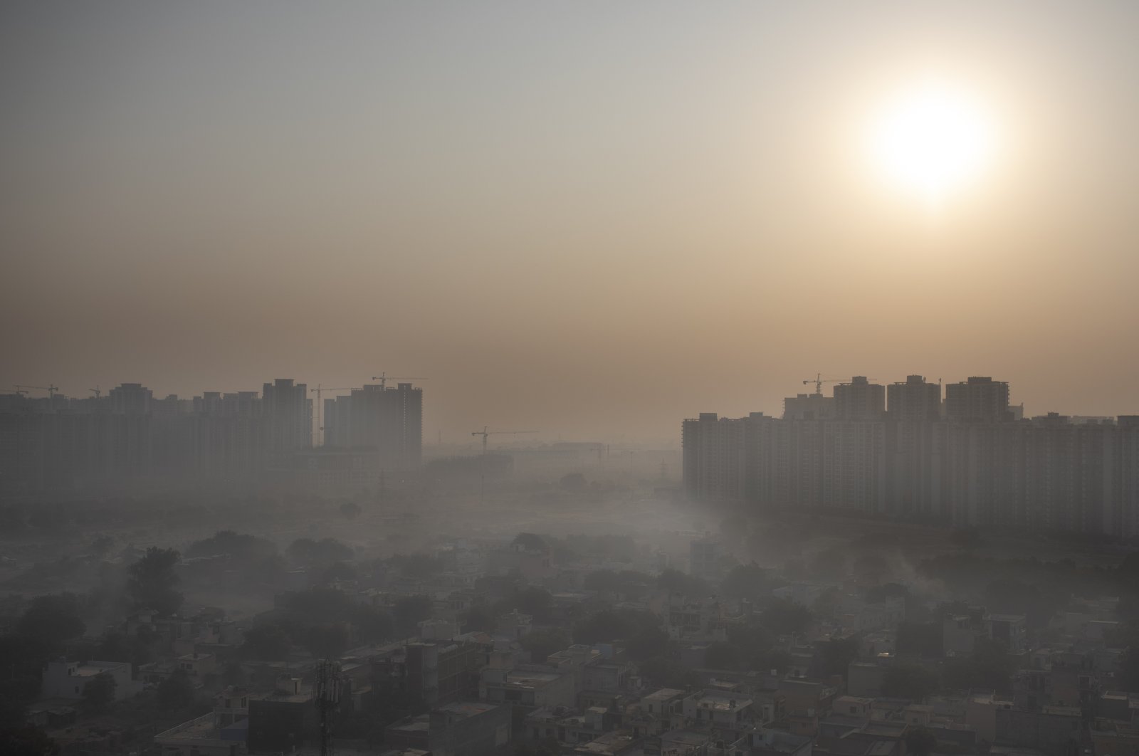 Morning haze envelops the skyline on the outskirts of New Delhi, India, Oct. 16, 2020. (AP Photo)