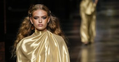 A model wears a creation from the Fendi spring-summer 2022 collection during Milan Fashion Week, in Milan, Italy, Wednesday, Sept. 22, 2021. (AP Photo)