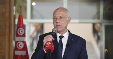 Tunisian President Kais Saied waves to Tunisian citizens as he delivers a speech during his visit to Sidi Bouzid, Tunisia, Sept. 20, 2021. (AP Photo)