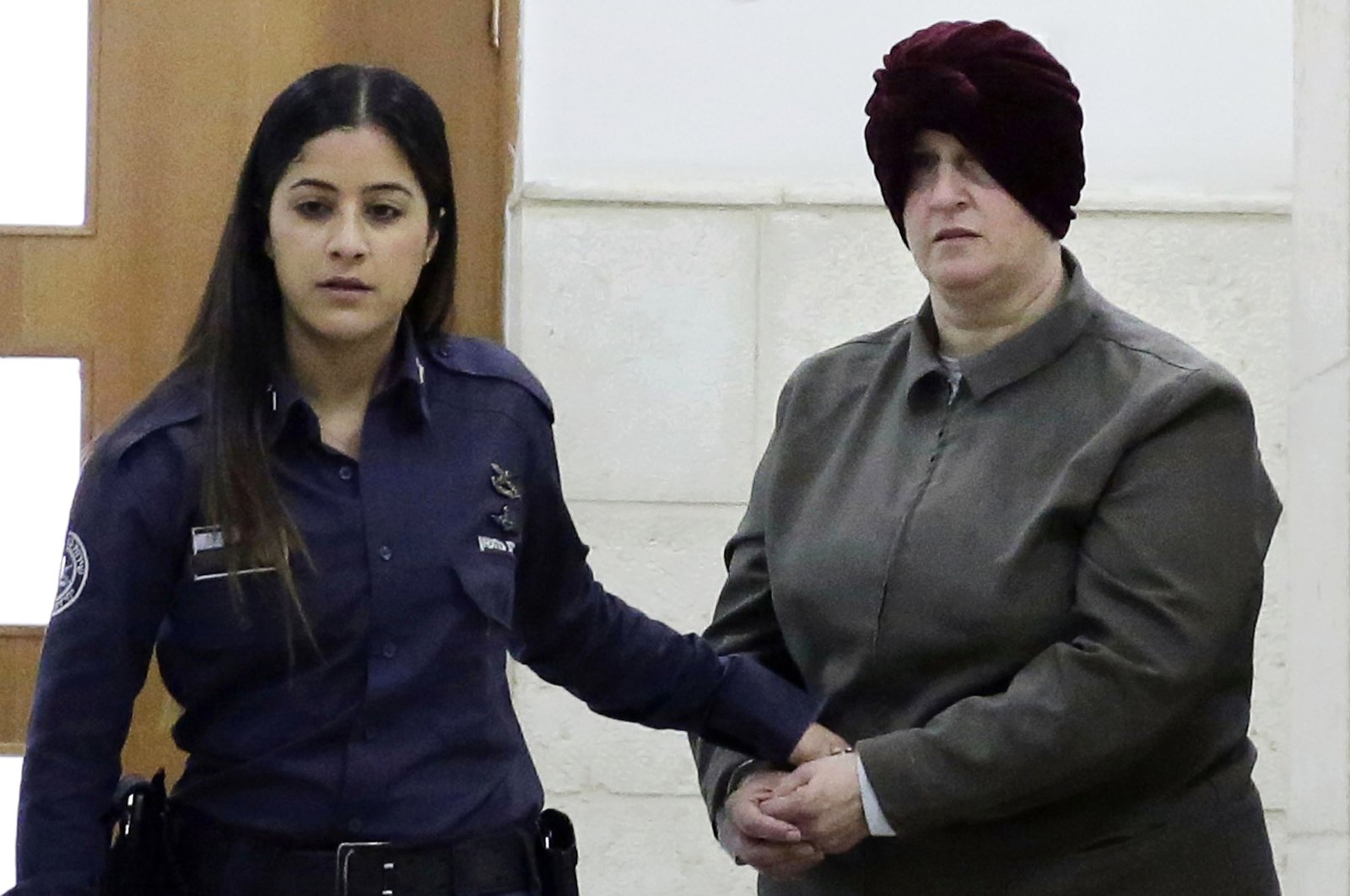 Israeli-born Australian Malka Leifer,(R), is brought to a courtroom in Jerusalem, Feb. 27, 2018. (AP Photo)