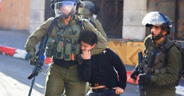 Israeli soldiers detain a Palestinian boy, in Hebron, Israeli-occupied West Bank, Sept. 23, 2021. (Reuters Photo)